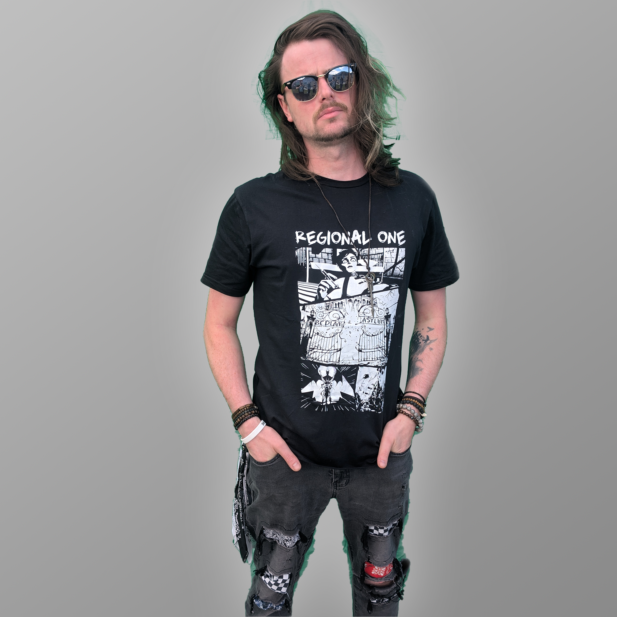 Regional One Bedlam T-shirt featuring an illustrated Bedlam design on the front modelled by Stevie Lees